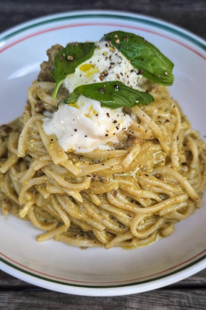 Home-made Spaghetti alla chitarra, pistacchio pesto, sausage and stracciatella