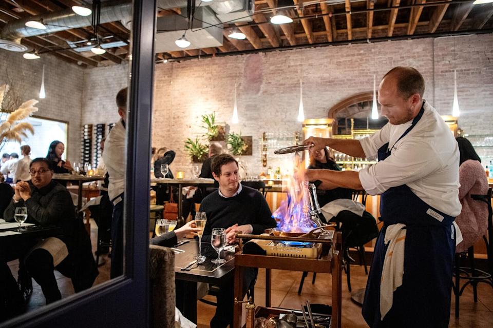 Chef Dave Beran prepares his pressed duck at a table at Pasjoli in 2019.