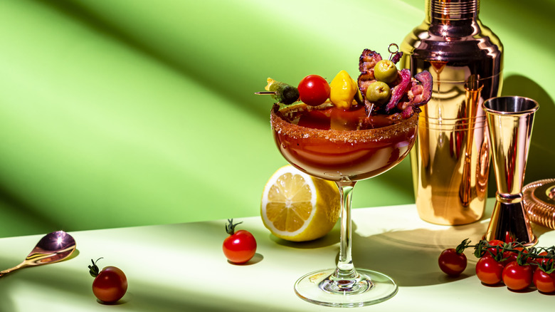 Savory cocktail with tomatoes and red salt on the rim