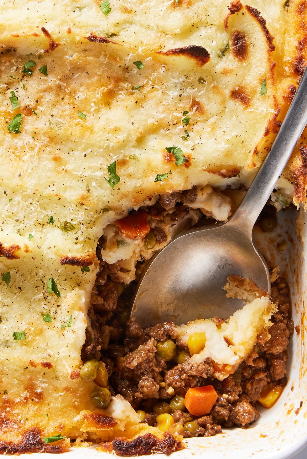 ground beef cooked with aromatics and red wine, then combined with corn and peas and covered with a blanket of velvety, rich mashed potatoes, then topped with parmesan and broiled until golden brown
