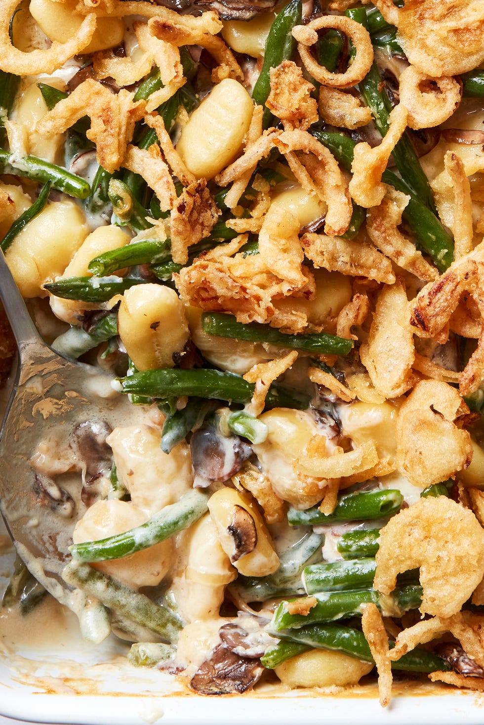blanched fresh green beans and buttery sliced mushrooms, onions, and garlic get tossed with a creamy bechamel sauce and pillowy gnocchi then baked until bubbly