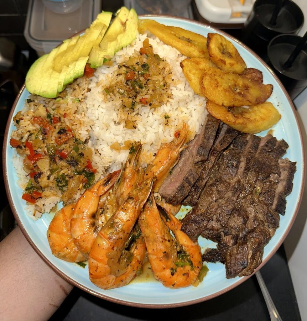 Coconut shrimp, skirt steak, plantains, avocado and rice.