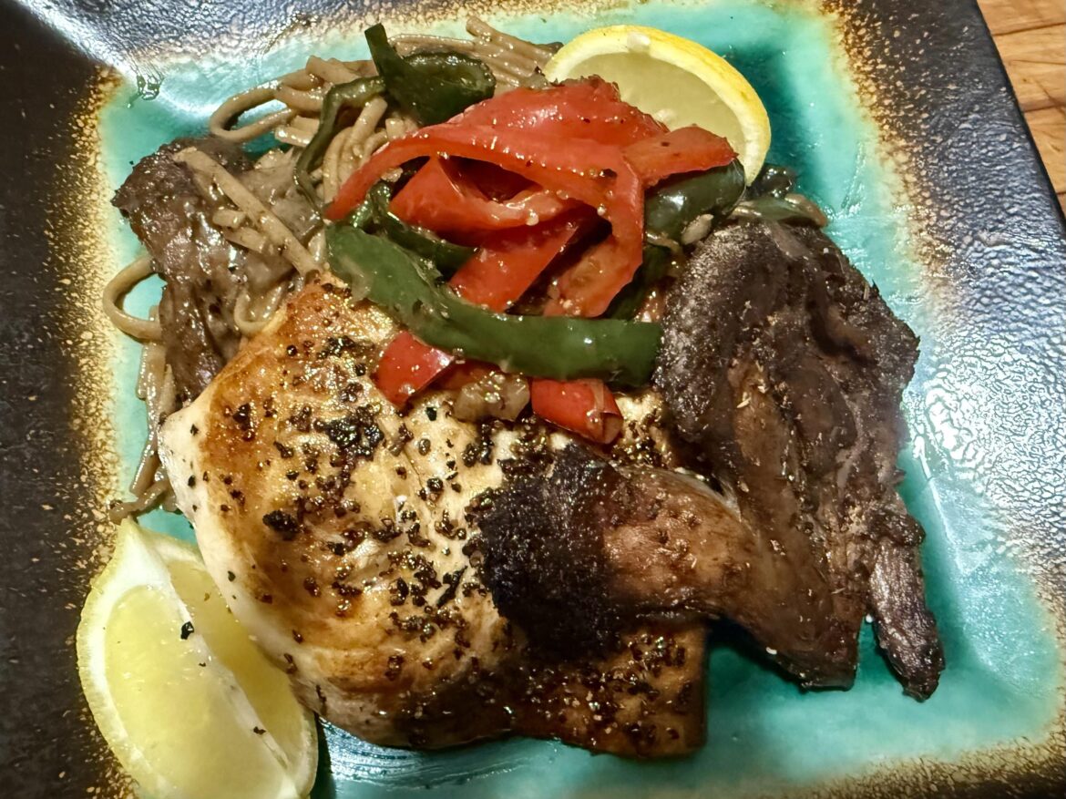 Seared swordfish and lions mane steak over linguine with a lions mane and porcini mushroom bisque sauce, topped with sautéed peperanata