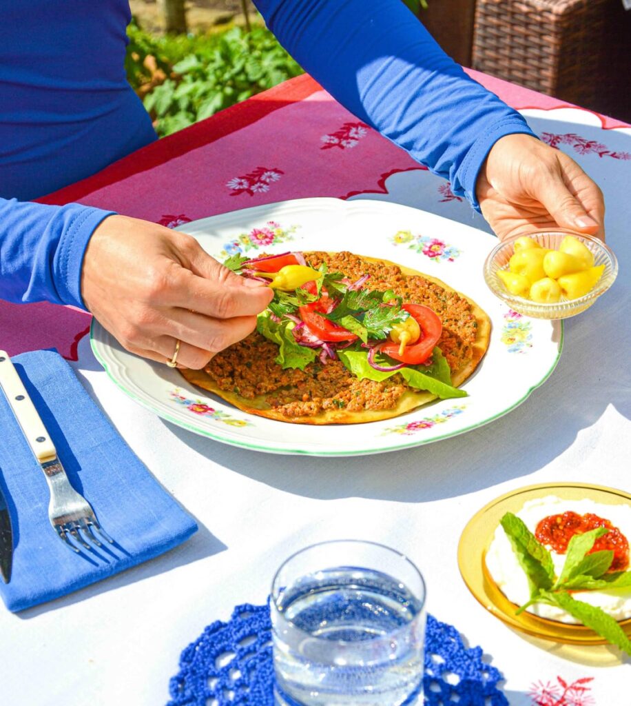 Lahmacun - flatbread topped with spiced beef and vegetables, sumac red onion salad, labneh and pickled chillies