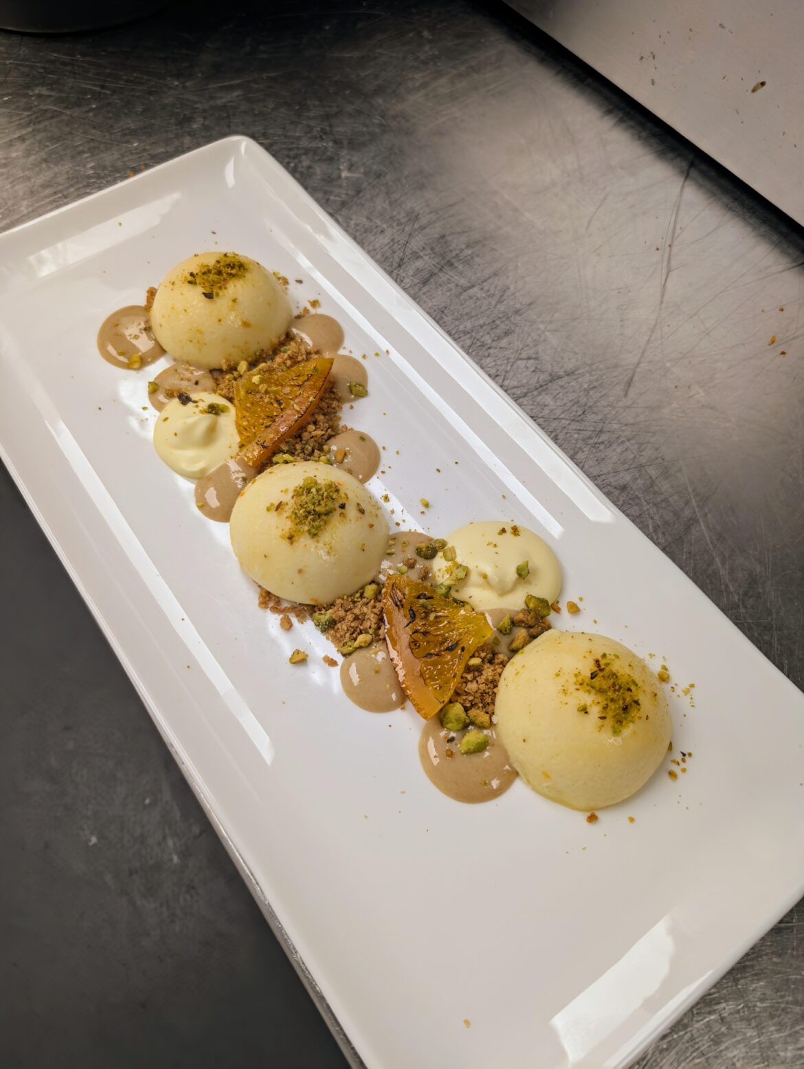 Saffron Blood Orange Cheesecake|Graham Crumble|Date Creme Anglaise|Passion Fruit Cream|Candied Orange|Pistachio