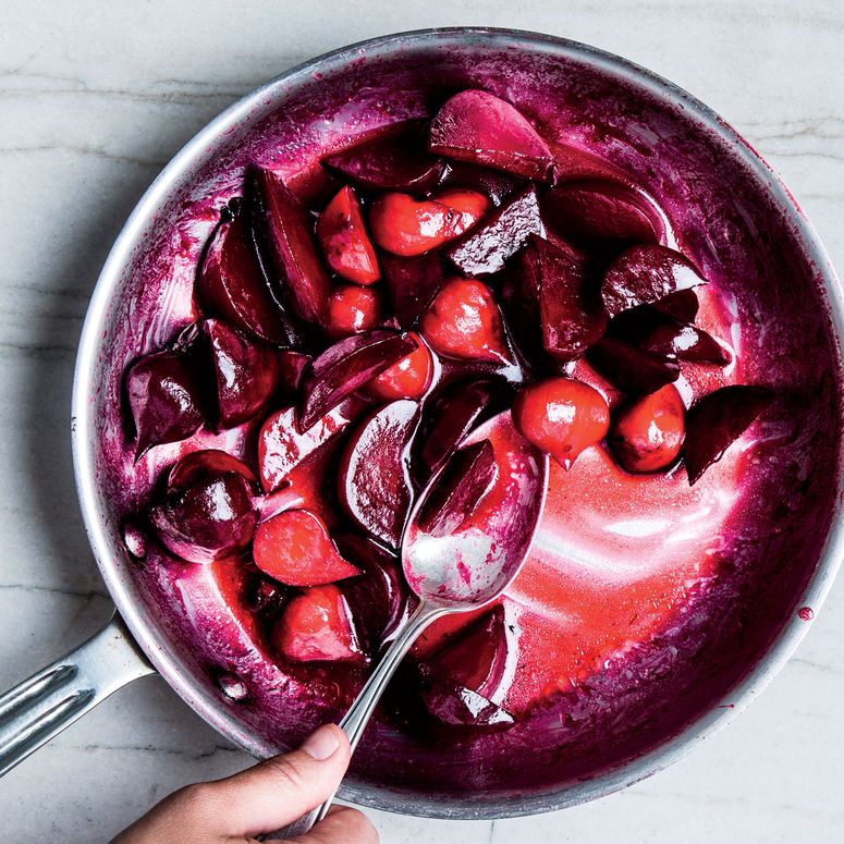 Purplered vegetables glazed in a pan.