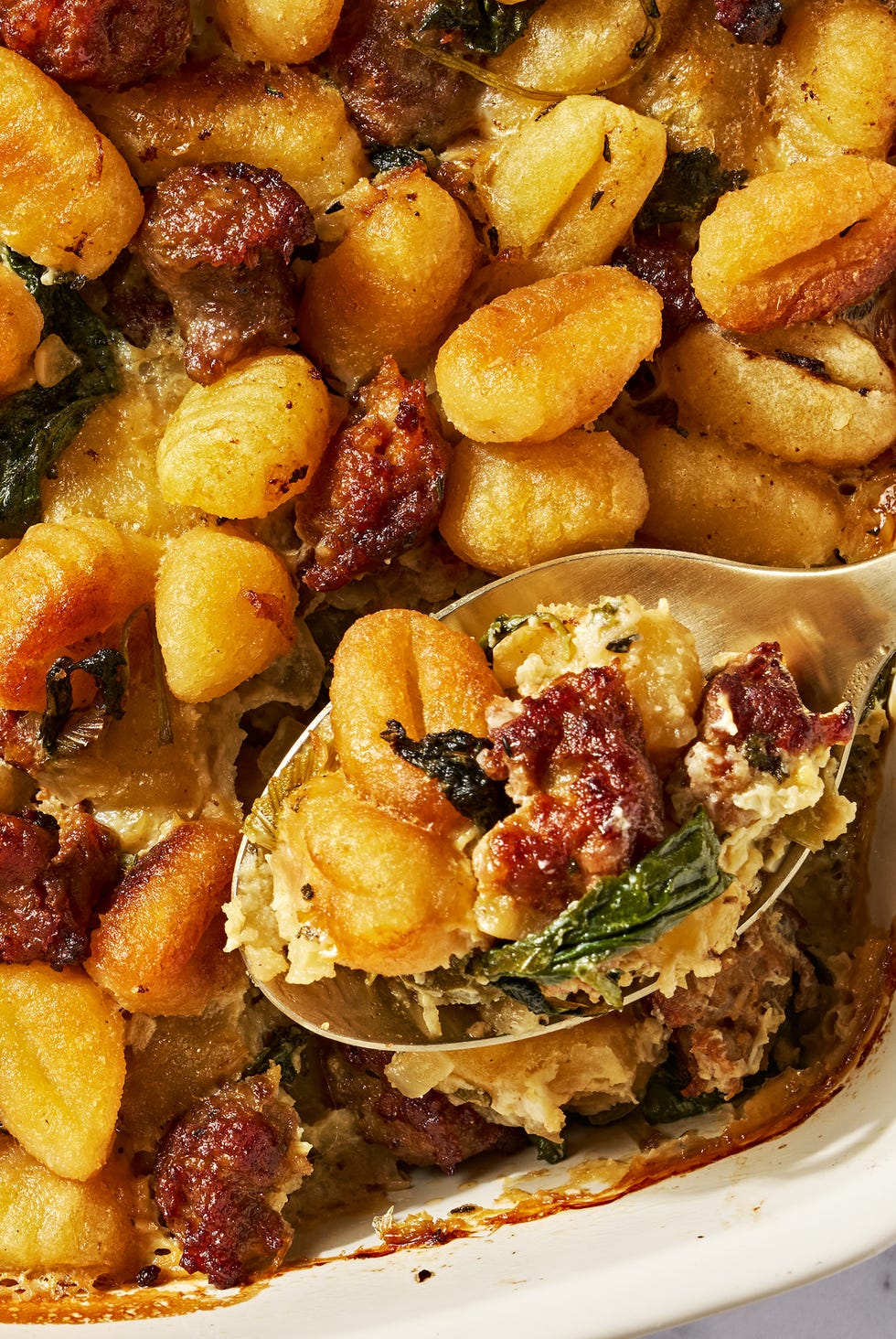 gnocchi and sausage stuffing in a white baking dish