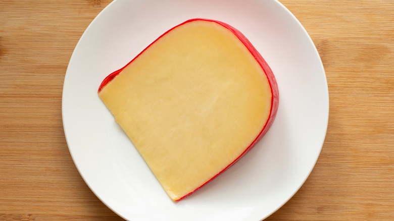 Wedge of Gouda cheese on a plate