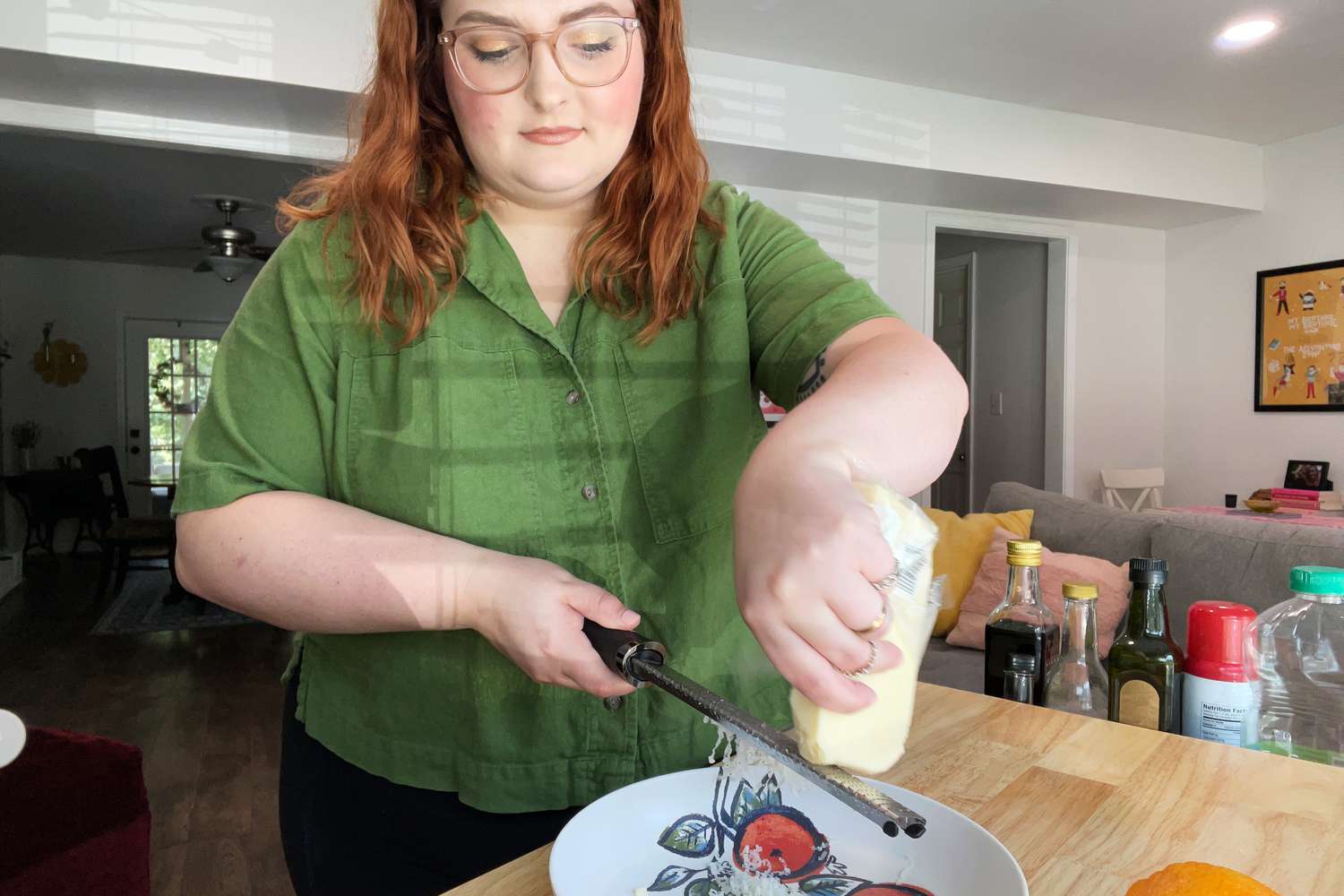 Person grating a block of cheese with the Microplane Premium Zester