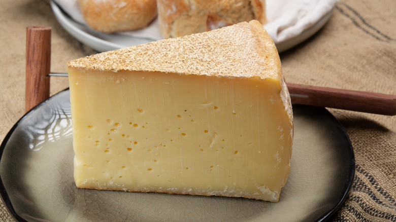 Wedge of Gruyère cheese on plate