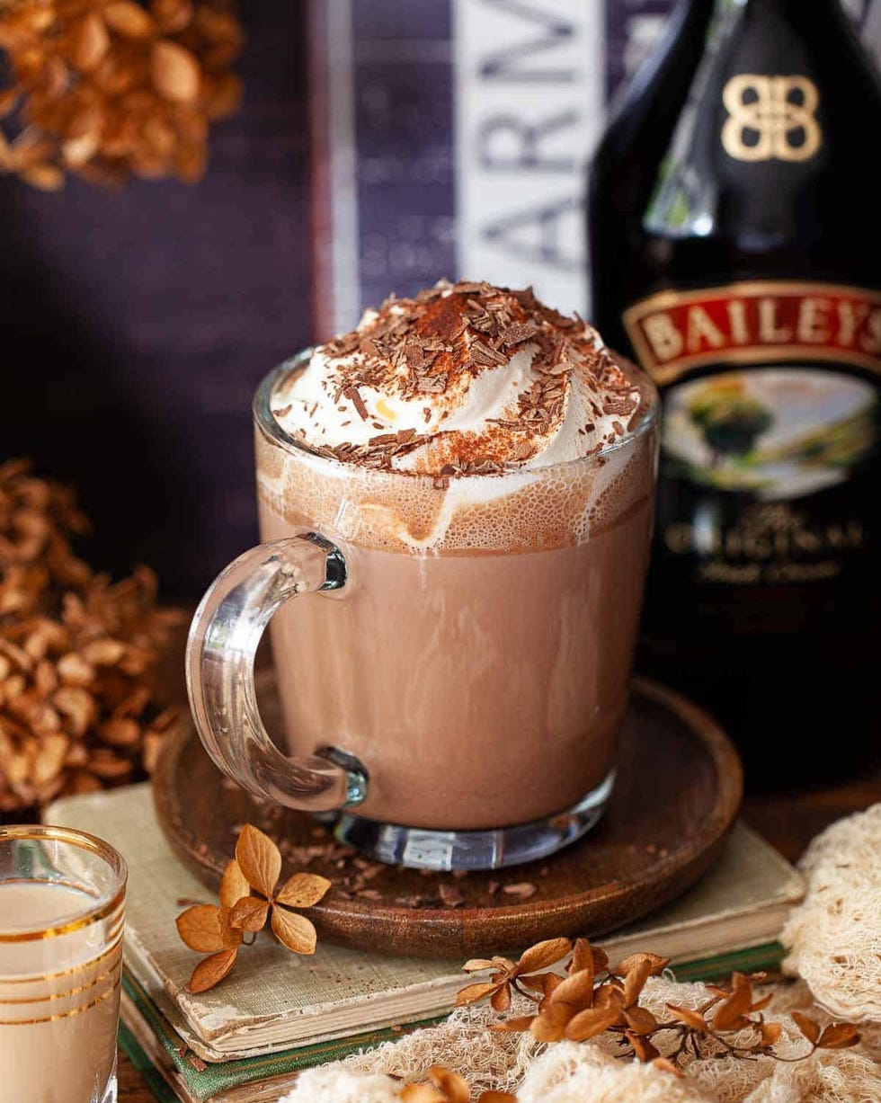 baileys hot chocolate with whipped cream in glass mug