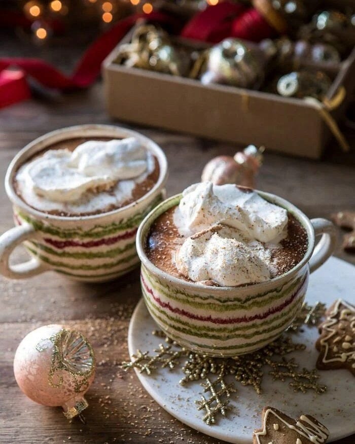vanilla mocha hot cocoa in christmas mugs with cookies and ornaments around