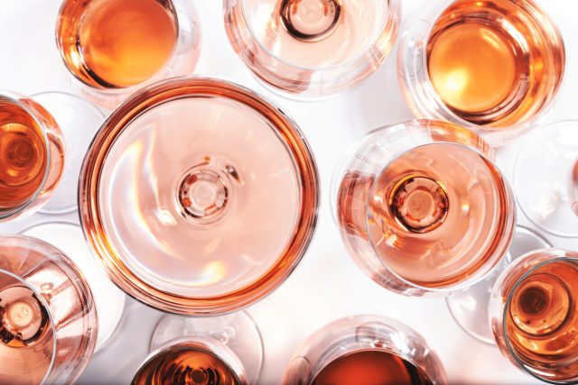 Rose wine glasses set on wine tasting. Different varieties, colors and shades of pink wines on white background. Top view. Rosé may no longer be the booming juggernaut it once was, but its evolution from trend to trusted category reveals a more resilient and refined market. Provence, in particular, is emerging as the new gold standard for pink wine lovers, writes Kathleen Willcox.