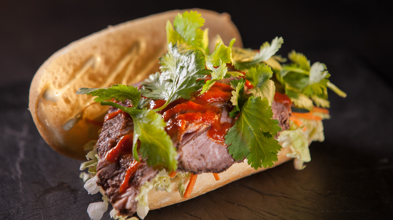 A bánh mì sandwich bursting with fillings