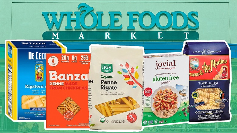 Five packages of pasta in front of a Whole Foods sign