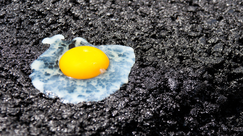 egg cooking on fresh asphalt