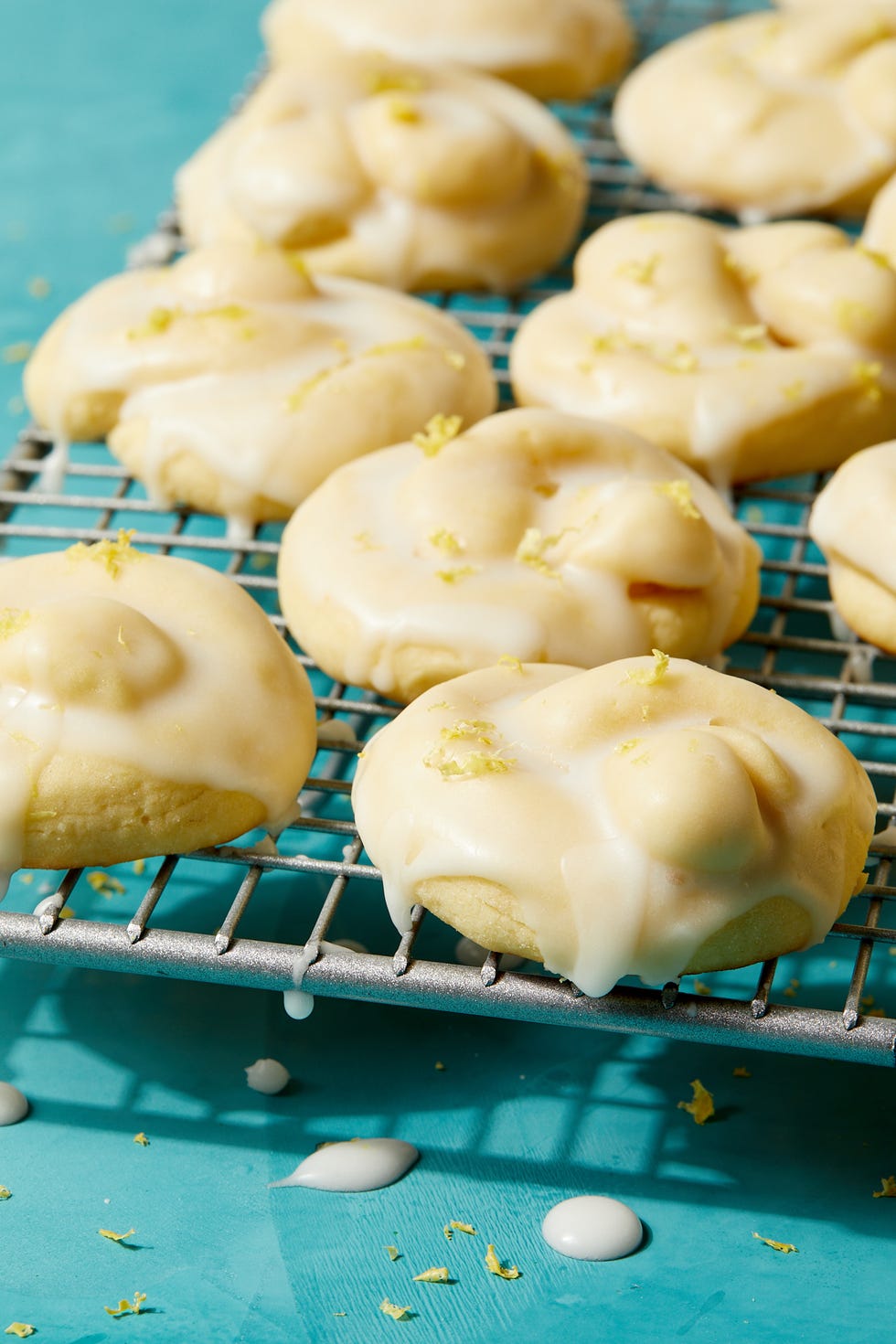 italian lemon cookies covered in an white icing glaze and lemon zest
