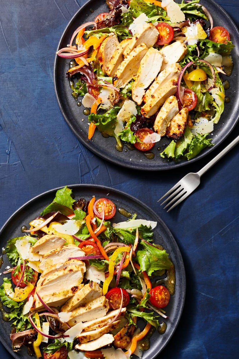 healthy air fried chicken over a bed of salad