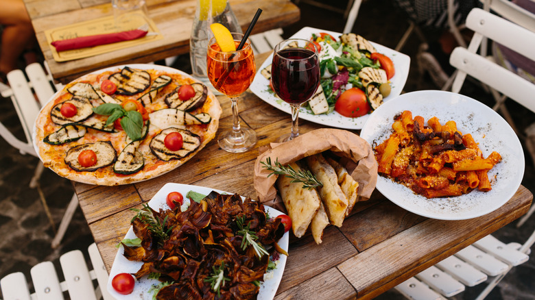 Plates of Italian dishes on an outdoor table