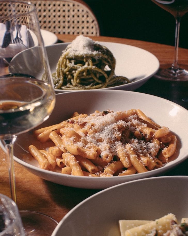 A bowl of pasta topped with cheese at Post