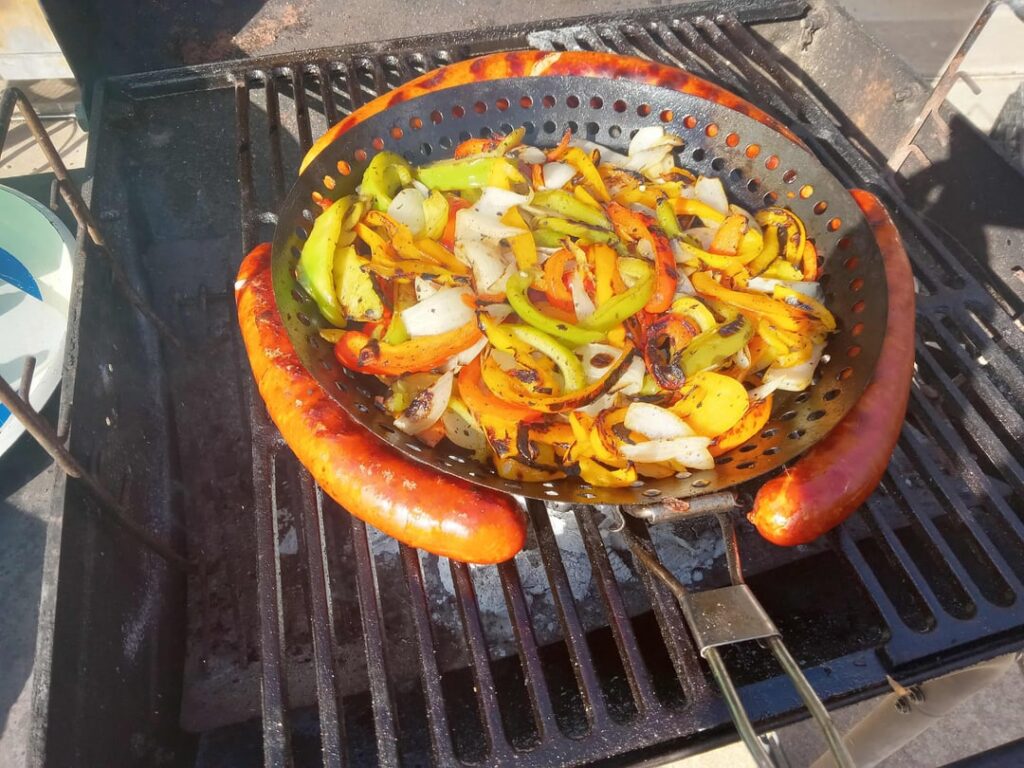 Grilling pig gut-cased snausages until they scream, wiggle, and squirt.