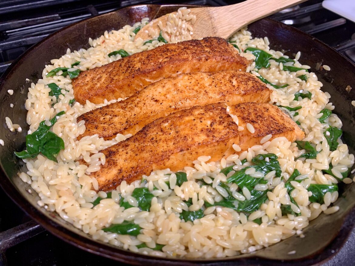 Salmon with lemon orzo and wilted spinach.