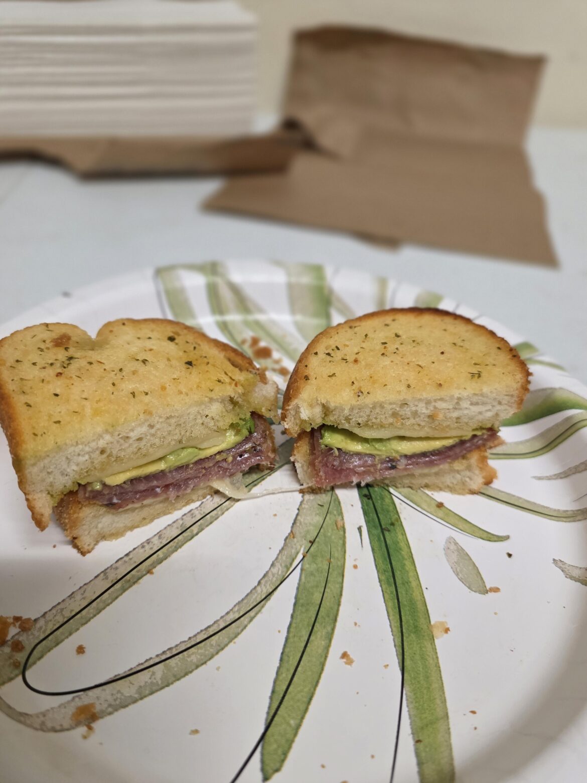 Homemade Lunch today. 2 pieces of texas toast, sprinkled with parmesan, melted Swiss, salami slices, and avocado.