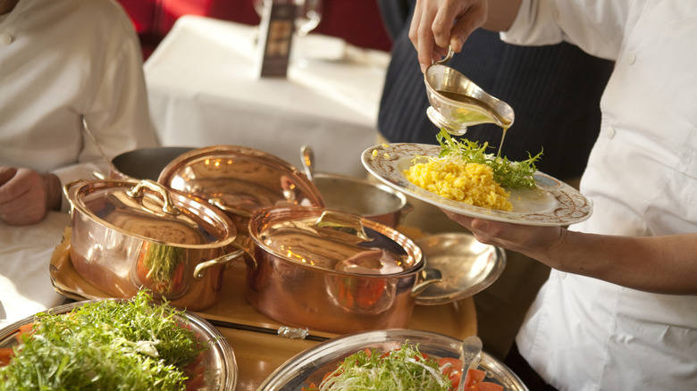A chef providing table side service at Le Grand Véfour in Paris, France