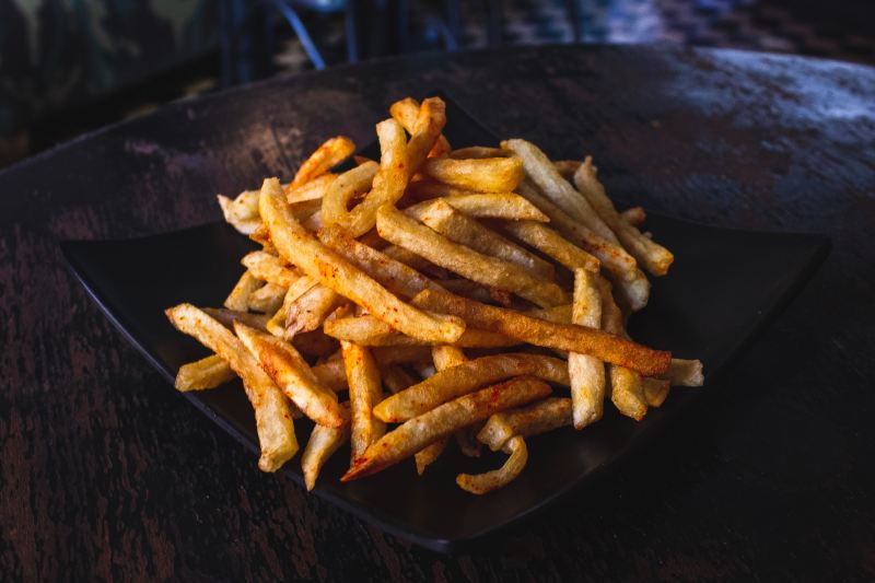 French fries on a black plate