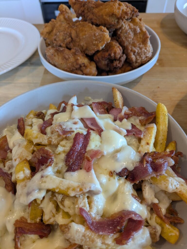 Homemade fried chicken tenders and cheesy chips.