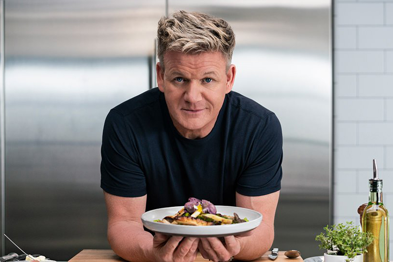 Gordon Ramsay holding a plate of food during a masterclass