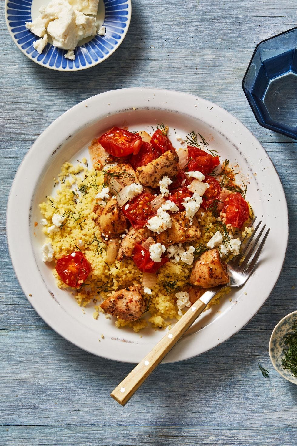 healthy air fryer mediterranean chicken bowls with tomatoes, cheese and couscous
