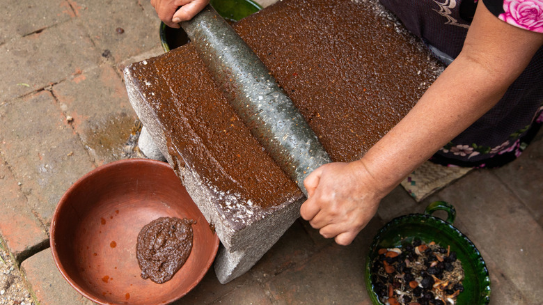 Oaxaca chiles being ground with metate