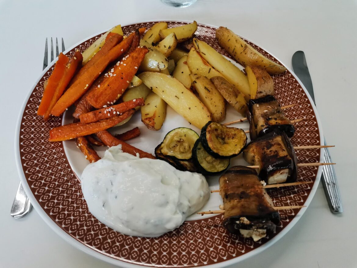 Homemade baked potato wedges, baked carrots, fried zucchini, and eggplant rolls with feta filling.