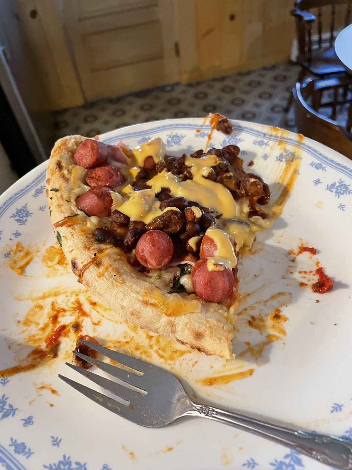 Am I guilty? Frozen cheese pizza with chili and hotdogs and ham on it and a cheese sauce
