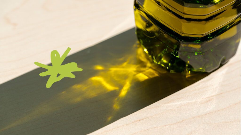 The bottom of a vegetable oil bottle casts a shadow on a flat surface