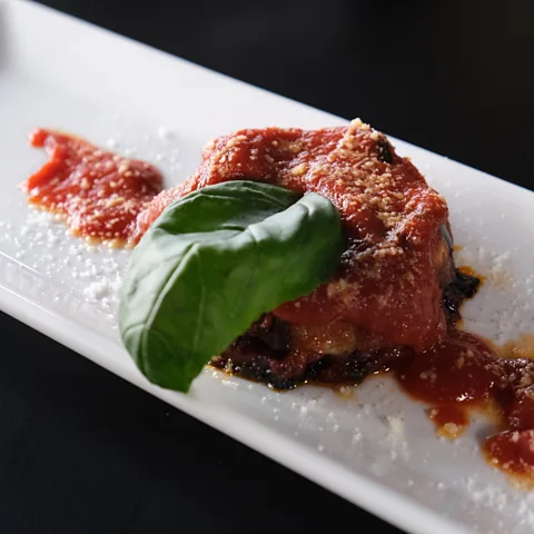 Getty Images Gooey and comforting, aubergine parmigiana is a quintessential Neapolitan dish (Credit: Getty Images)