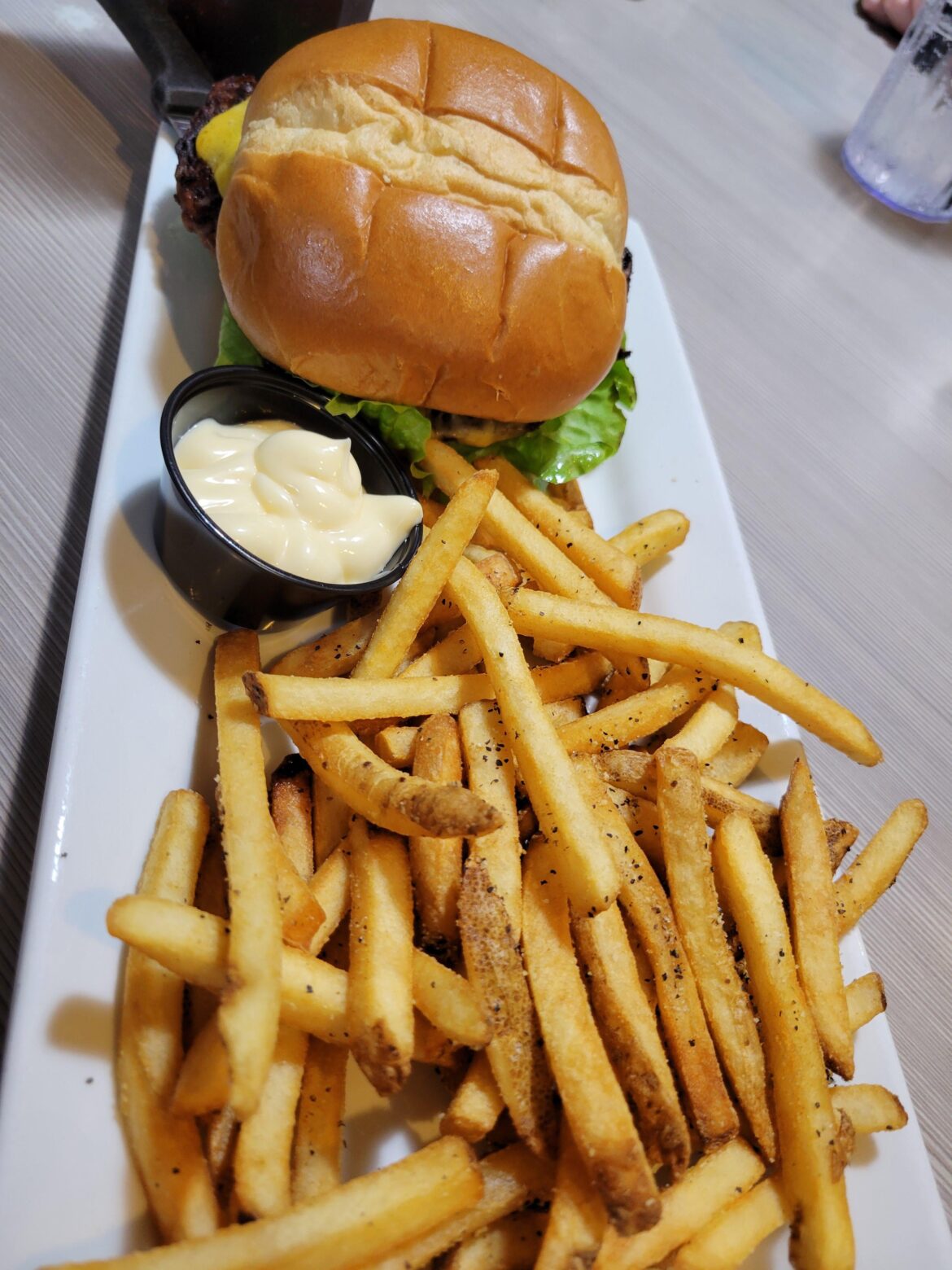A veggie burger with seasoned french fries.