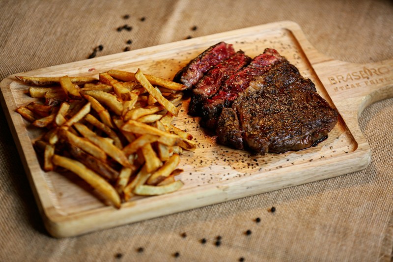 Steak frites on a wooden board