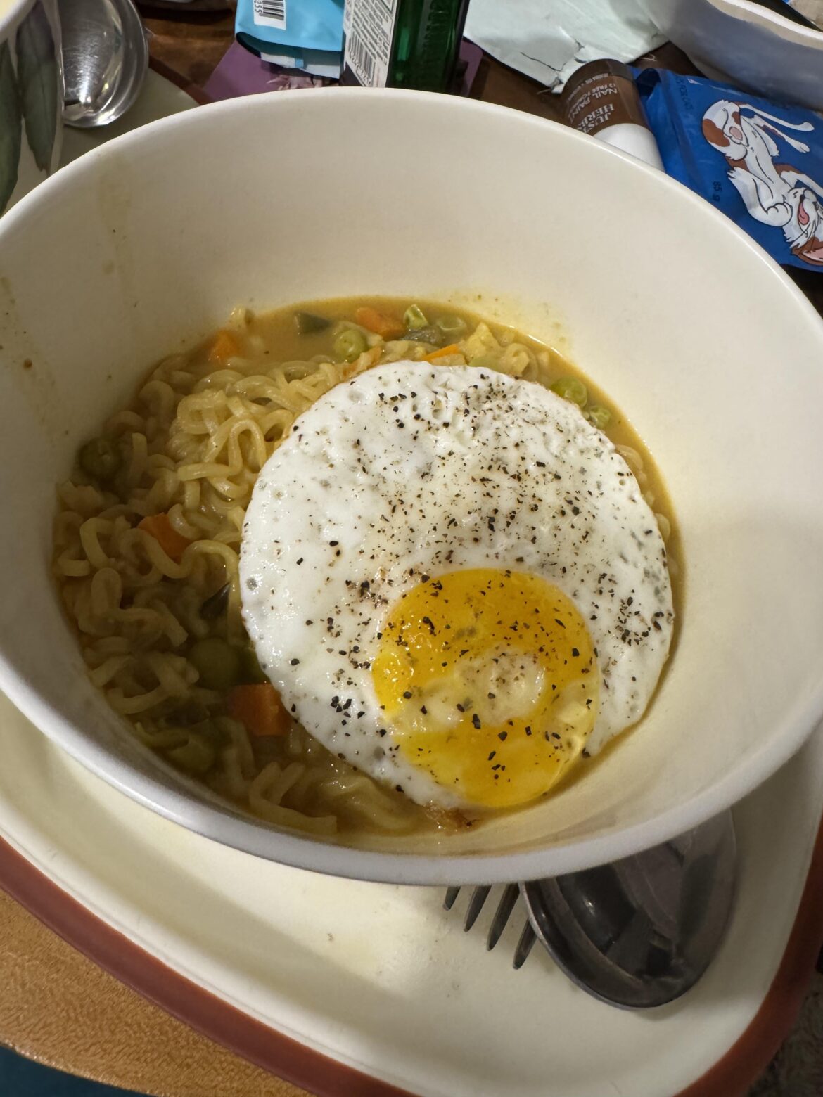 Veggies, noodles and a fried egg! Hack: Add Water, Bouillon Cube and Cheese to make it creamy.