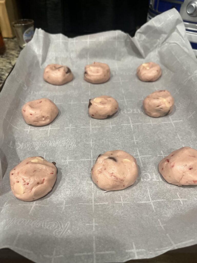 Strawberry cookies with black and white chips.