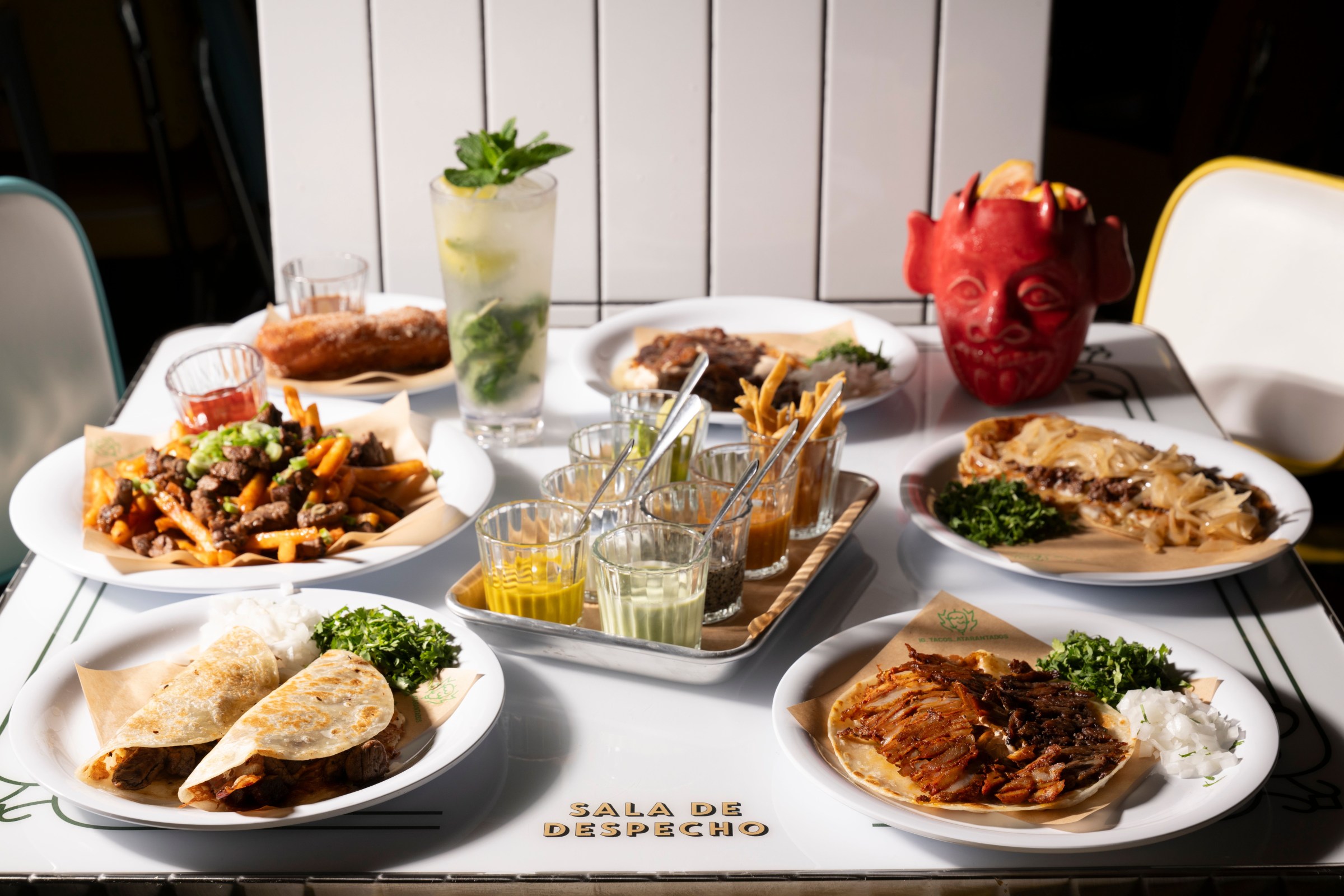A table full of tacos and cocktails.