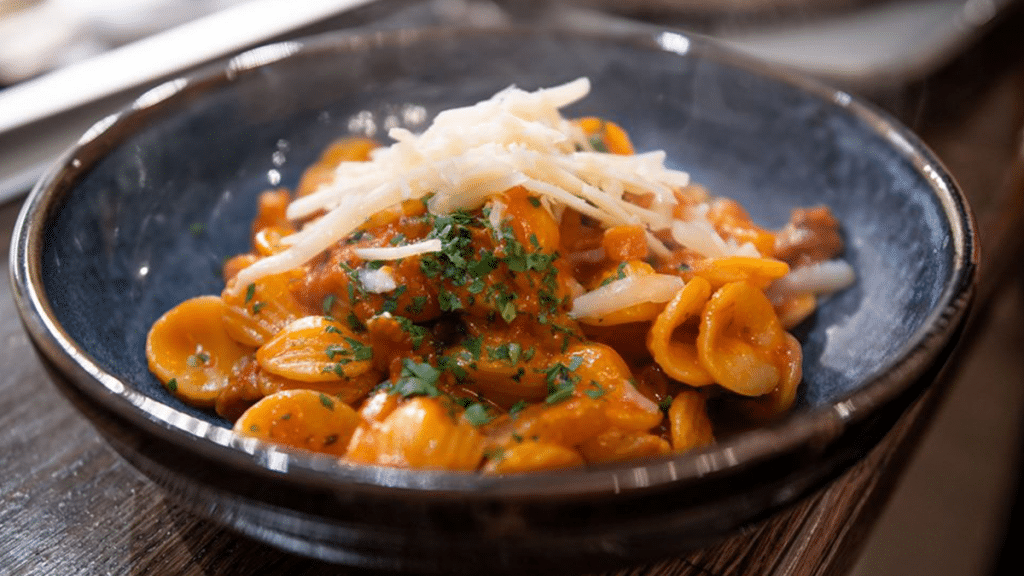 A delicious plate of pasta, herbs and cheese at Salvi's – one of the best Italian restaurants in Manchester