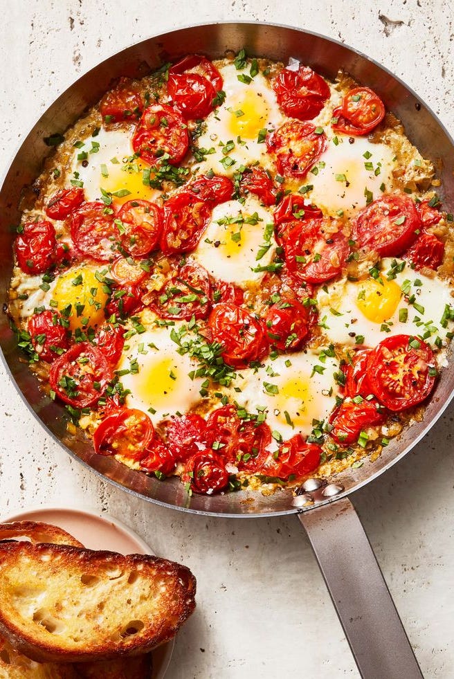 shakshuka dish of tomatoes and eggs in a skillet