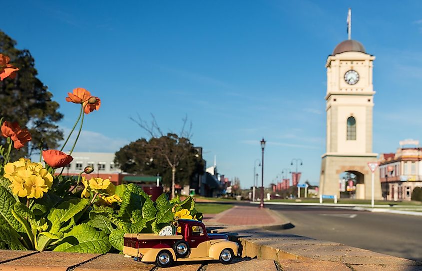A model pickup truck with a gold pocket watch on the back of it, in Feilding, New Zealand.