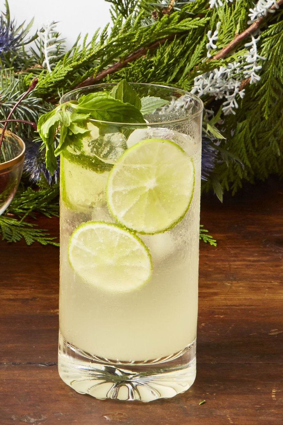 a glass of sparkling wine mojito punch on a wooden table