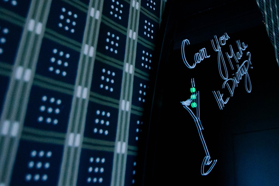 The words "Can you make it dirty?" and a martini glass are drawn on a restaurant mirror in liquid chalk.