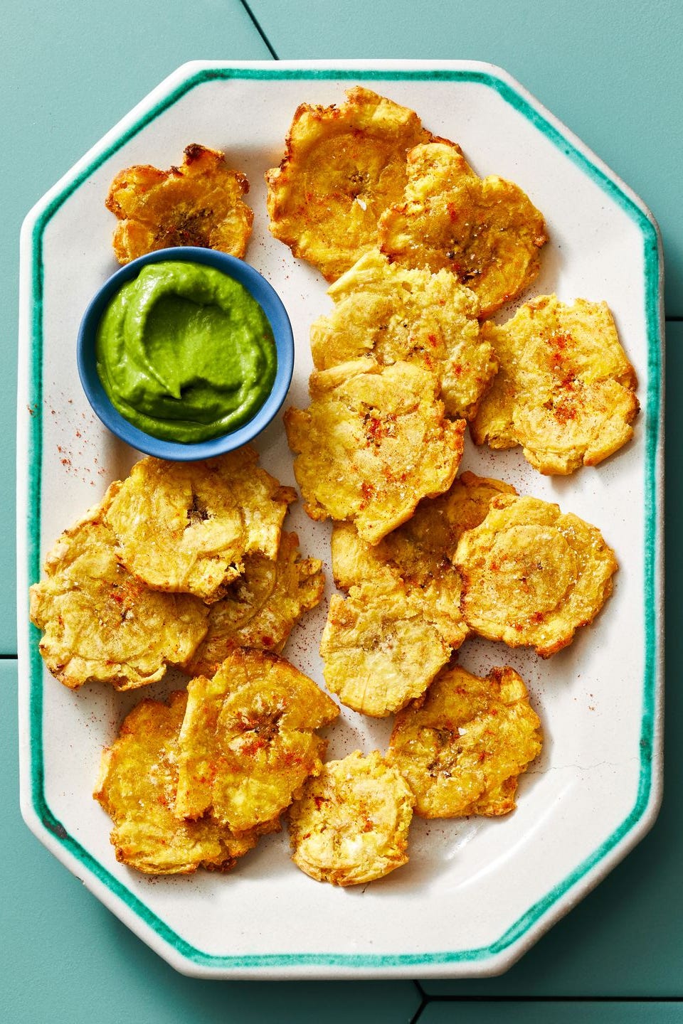 healthy air fryer tostones with a side of green sauce