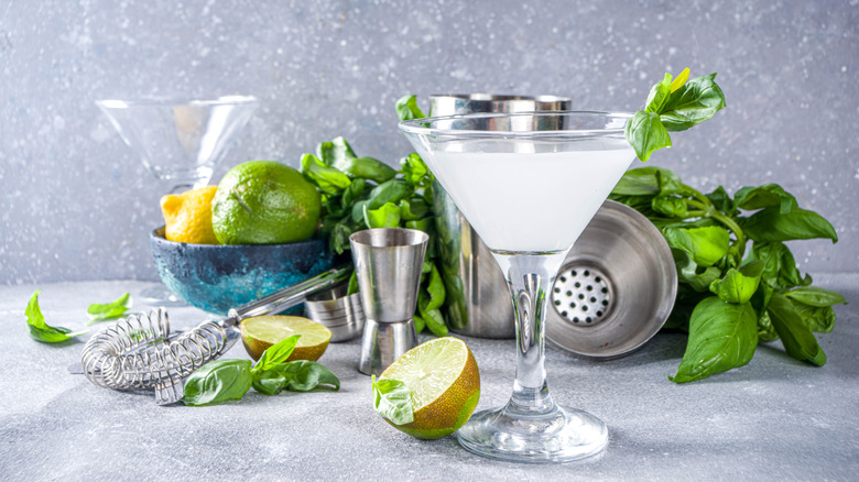 Gimlet with basil leaves and limes