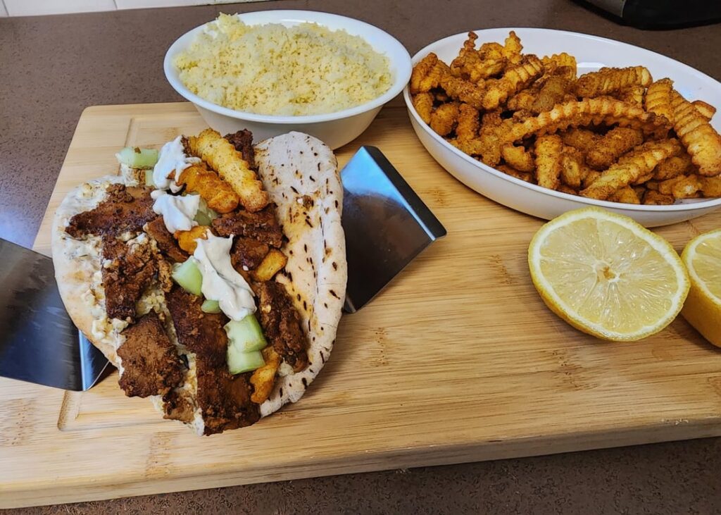 Homemade tofu gyros with curry fries and couscous